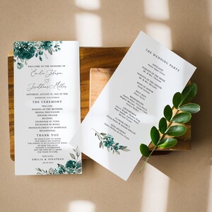 May include: Wedding ceremony program with a teal floral design. The program lists the order of events for the wedding ceremony, including the seating of the mothers, the bridal procession, and the exchange of vows. The program also includes a thank you message from the couple.