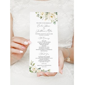 May include: A wedding ceremony program with white flowers and green leaves. The program lists the order of events for the wedding of Emilia Johnson and Jonathan Miller on August 20, 2022, in Woodside, California.