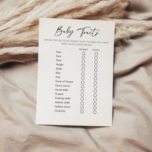 May include: A printable baby shower game with the title "Baby Traits" and a list of traits like "Eyes", "Ears", "Nose", "Height", "Smile", "Skin", "Hair", "Sense of Humor", "Dance moves", "Social skills", "Temper", "Cooking skills", "Athletic skills", "Fashion sense", and "Creativity".  There are two columns for guests to guess whether the baby will inherit the trait from the mommy or the daddy.