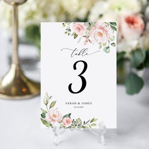 May include: White table number card with pink and green floral design. The card says "Table 3" and "Sarah & James 10.14.2022".