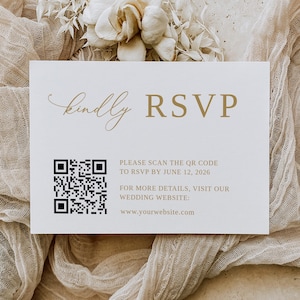 May include: A white RSVP card with a gold "kindly RSVP" heading. A black and white QR code is below the heading with the text "PLEASE SCAN THE QR CODE TO RSVP BY JUNE 12, 2026. FOR MORE DETAILS, VISIT OUR WEDDING WEBSITE: www.yourwebsite.com"