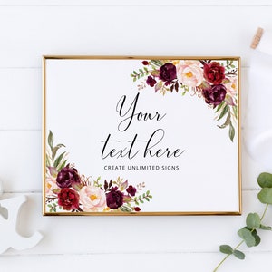 Peut inclure: Un panneau encadr&eacute; avec une bordure dor&eacute;e, orn&eacute; de compositions florales bordeaux, cr&egrave;me et vertes. Le panneau porte le texte "Your text here" et "Create unlimited signs". Un esperluette et un ruban blancs sont &eacute;galement pr&eacute;sents.