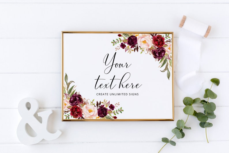 Peut inclure: Un panneau encadr&eacute; avec une bordure dor&eacute;e, orn&eacute; de compositions florales bordeaux, cr&egrave;me et vertes. Le panneau porte le texte "Your text here" et "Create unlimited signs". Un esperluette et un ruban blancs sont &eacute;galement pr&eacute;sents.
