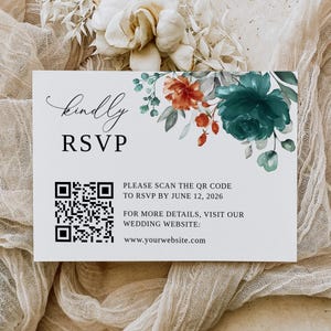 May include: A white RSVP card with a floral design in shades of teal, orange, and green. The card includes a QR code and the text "kindly RSVP", "PLEASE SCAN THE QR CODE TO RSVP BY JUNE 12, 2026", "FOR MORE DETAILS, VISIT OUR WEDDING WEBSITE:", and "www.yourwebsite.com".
