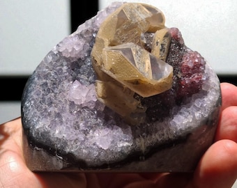 Amethyst druse with calcite and iron oxide from Brazil.