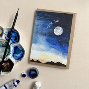 Tarjeta de felicitación de acuarela con luna y estrellas pintada a mano