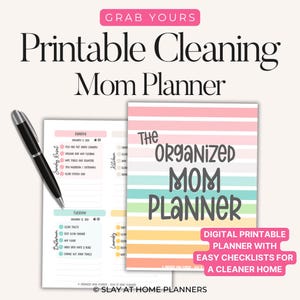 May include: A digital printable cleaning mom planner with easy checklists for a cleaner home. The planner features a colourful striped cover with the text "The Organised Mom Planner". A black pen rests on the open planner pages.