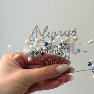 May include: A silver hair comb featuring the word "Always" and a Deathly Hallows symbol. It is decorated with white and blue beads and pearl accents. A matching hair accessory is also included.