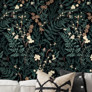 May include: Dark wallpaper featuring a botanical pattern of green ferns, white flowers, and brown pinecones against a black background. The design includes a variety of plant life, creating a natural, textured look. The wallpaper is suitable for interior decor.