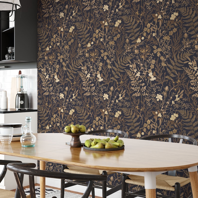 May include: A dining room with dark blue wallpaper featuring a gold floral pattern. A wooden table with a light wood finish is set with two chairs and a bowl of pears.