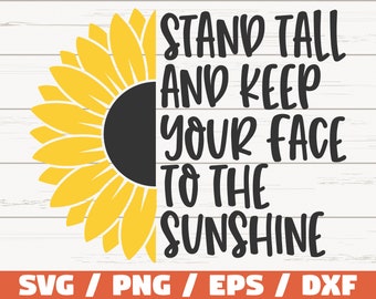 May include: A yellow sunflower with a black center and the text "STAND TALL AND KEEP YOUR FACE TO THE SUNSHINE" in black. The text is on a white wood background.