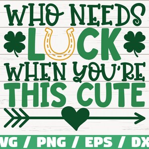 May include: Green and gold graphic with the text "WHO NEEDS *LUCK* WHEN YOU'RE THIS CUTE" with a green arrow and heart in the center.  The text is on a white wood background.