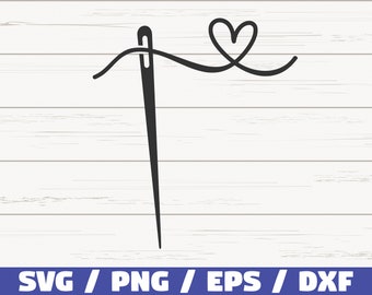 May include: A black needle with white thread threaded through it, with a heart-shaped loop of thread at the top. The image is on a white woodgrain background.