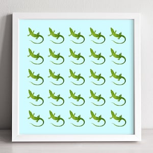 May include: A white framed print with a light blue background featuring a repeating pattern of green lizards.