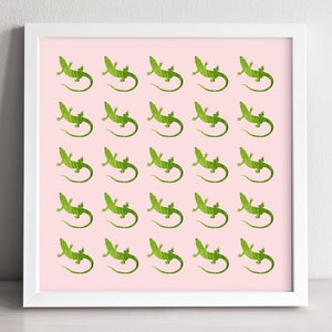 May include: A white framed print with a pink background and a repeating pattern of green lizard silhouettes.