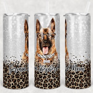 May include: Three stainless steel tumblers with a silver glitter background and a German Shepherd dog wearing glasses and a bone-shaped collar. The tumblers have a leopard print design at the bottom with the text "German Shepherd Mom" on the tumblers.