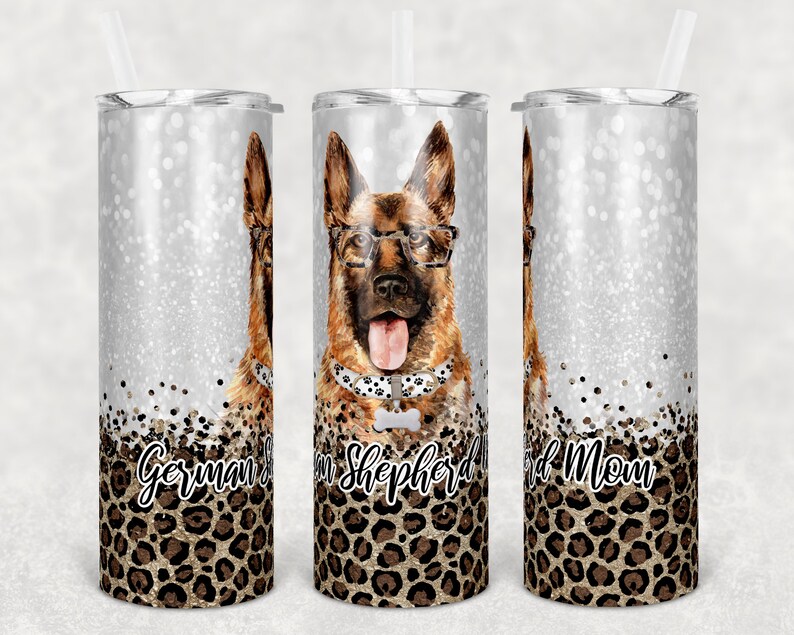 May include: Three stainless steel tumblers with a silver glitter background and a German Shepherd dog wearing glasses and a bone-shaped collar. The tumblers have a leopard print design at the bottom with the text "German Shepherd Mom" on the tumblers.