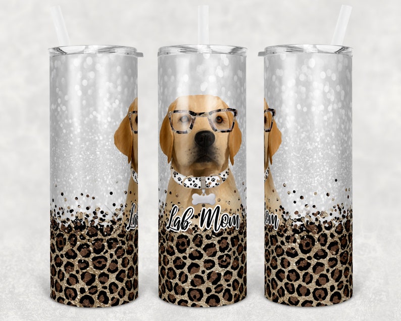 May include: Three stainless steel tumblers with a glitter background and a leopard print design. The center tumbler features a cartoon Labrador Retriever wearing glasses and a bow tie with the text "Lab Mom" on the bottom.