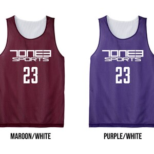 May include: Four reversible athletic jerseys in iron grey, maroon, purple, and kelly green. Each jersey has a white interior and features the text "JONES SPORTS" and the number "23" in white.