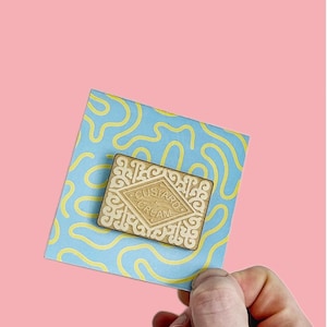 Custard cream / biscuit / pin / badge / lapel pin / snacks