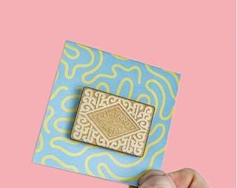 Custard cream / biscuit / pin / badge / lapel pin / snacks