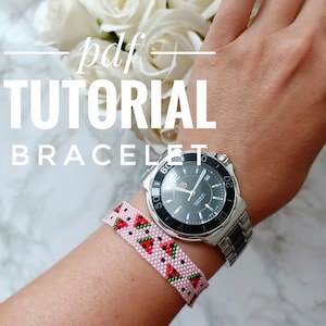 May include: A pink and green beaded bracelet with a watermelon pattern. The bracelet is worn on a person's wrist with a silver watch.