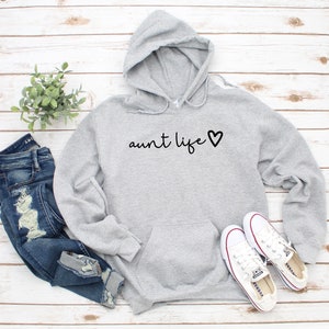 May include: Gray hooded sweatshirt with the text "aunt life" and a heart.