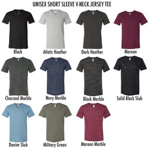 May include: A selection of unisex short sleeve V-neck jersey tees in various colors, including black, athletic heather, dark heather, and maroon. Other colors include charcoal marble, navy marble, black marble, solid black slub, denim slub, military green, and maroon marble.