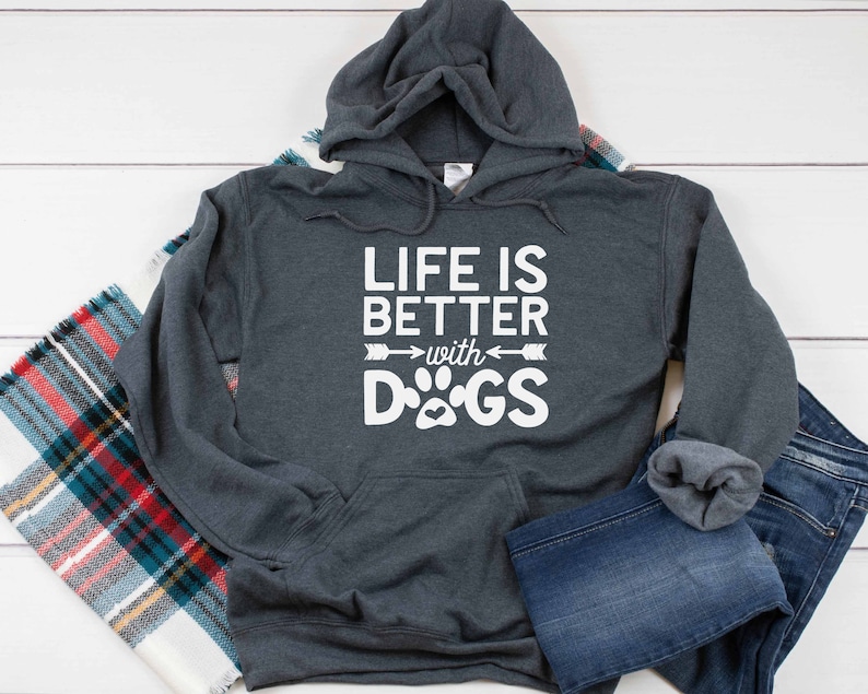May include: A dark gray hooded sweatshirt with the text "Life is better with DOGS" in white. The text is accompanied by a paw print and two arrows.