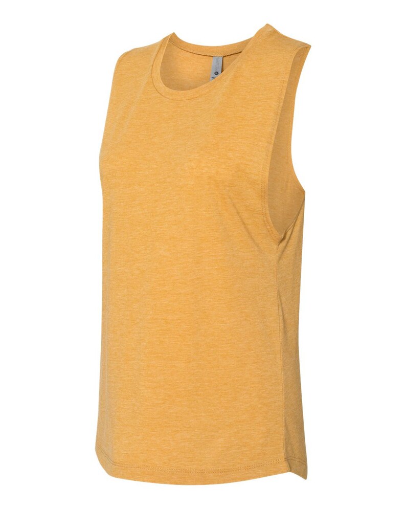 May include: A mustard yellow sleeveless shirt made of a soft, textured fabric. The shirt has a relaxed fit and a rounded neckline.