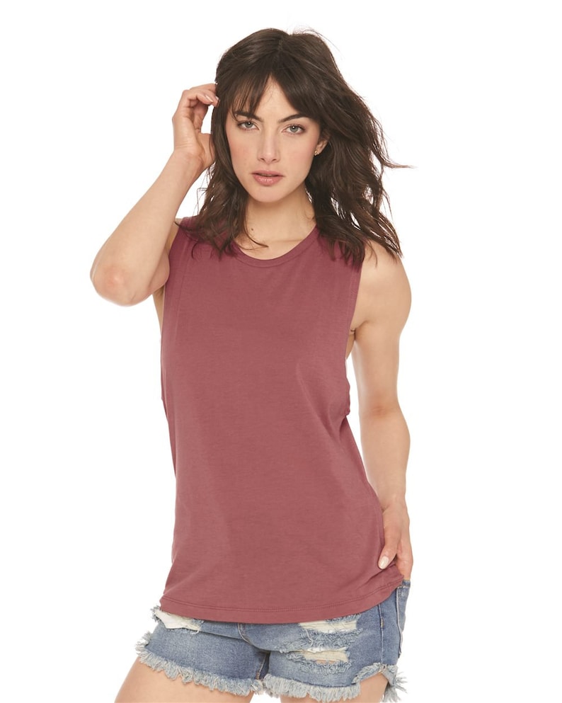 May include: A maroon sleeveless muscle tank top with a round neckline. The tank top is made of a soft, comfortable fabric.