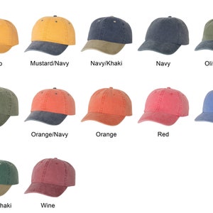 May include: A collection of baseball caps in various colors, including mango, mustard/navy, navy/khaki, navy, olive/navy, olive, orange/navy, orange, red, royal, spruce/khaki, and wine. Each cap has a curved brim and adjustable strap.