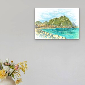 May include: A watercolor painting of a coastal town with a green hill in the background. The town is situated on the waterfront with boats docked in the harbor. The water is a bright turquoise blue.