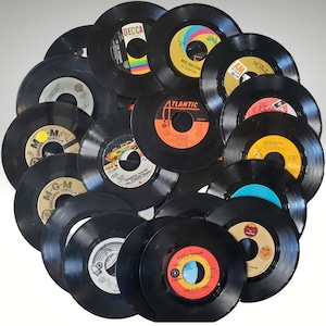 May include: A collection of vintage vinyl records in various colors, including black, white, red, and yellow. The records feature different artists and album titles, including "M-G-M Golden Circle", "Decca", "Atlantic", "Victor", and "Gotta Dream - The Fortunes".