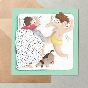 May include: A green card with a white bed and two people sleeping in it. The woman is on her side with her arm outstretched and a dog is sniffing her foot. The man is on his back with his arm outstretched. The bed has a black and white polka dot blanket.