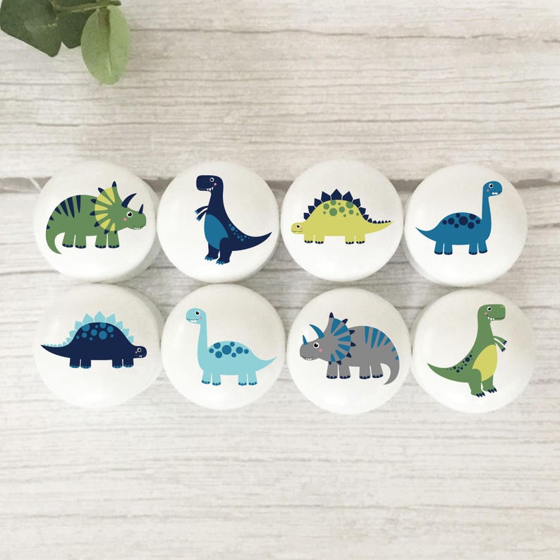 Solid white beech round furniture knobs with a colourful dinosaur illustration. Navy, lime, green, light blue, grey colour scheme.