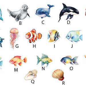May include: An alphabet chart featuring various sea creatures, including a dolphin, seal, whale, orca, crab, turtle, jellyfish, clownfish, angelfish, fish, seashell, and a starfish.