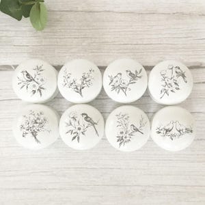 May include: A set of three ceramic mugs with a speckled, matte finish in cream, light grey, and dark grey. Each mug has a simple, minimalist design, ideal for coffee or tea.