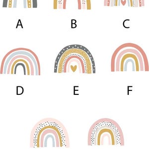Peut inclure: Ensemble de huit illustrations d'arc-en-ciel dans diff&eacute;rentes couleurs et motifs, notamment rose, bleu, jaune, gris et blanc. Chaque arc-en-ciel a un design diff&eacute;rent, comme des pois, des &eacute;toiles et des c&oelig;urs.