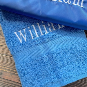 May include: A blue towel with the name "William" embroidered on it.