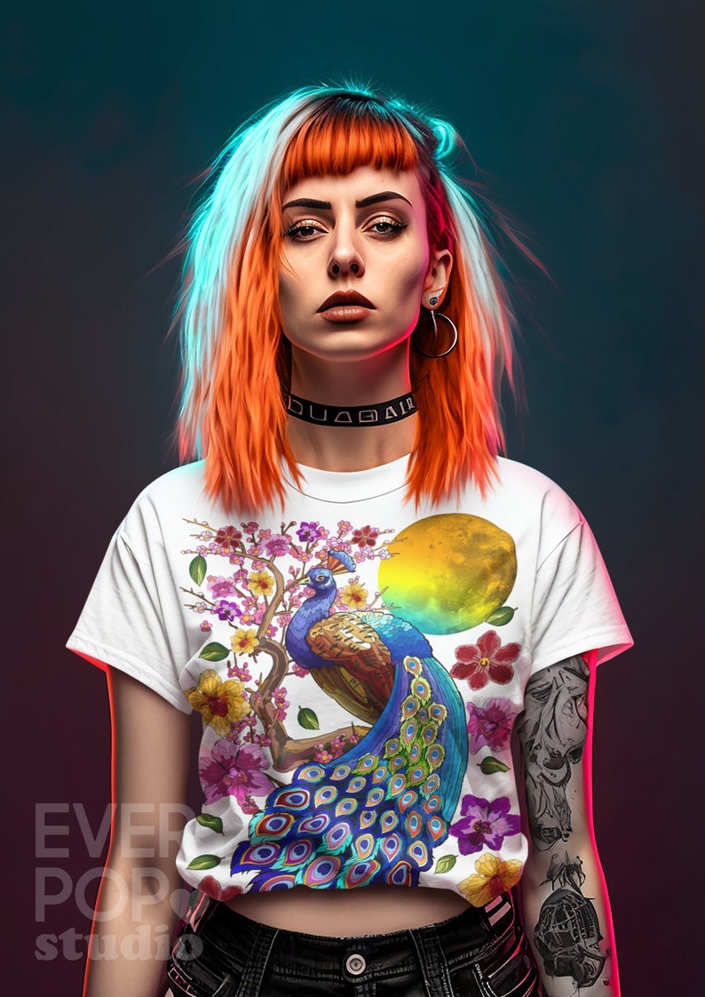May include: A white t-shirt with a colorful peacock design. The peacock is perched on a branch with pink flowers and green leaves. The background of the design is a yellow sun.
