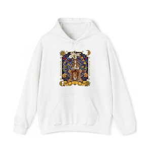 May include: White hoodie with a graphic print of a lion and a woman in a circle of stars. The graphic is surrounded by a gold frame and includes the text "Leo" and "SI LEO SI", with a sun and moon on either side.