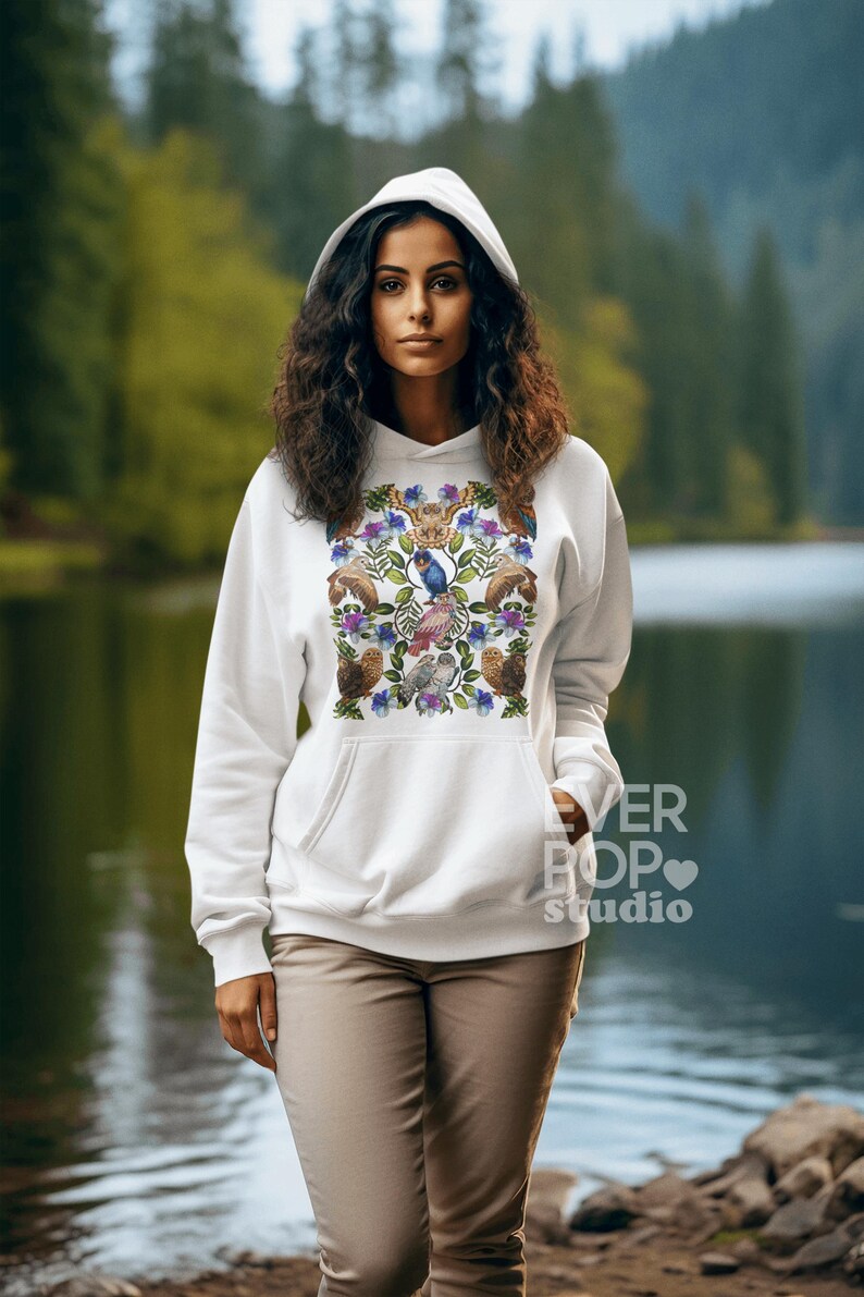 May include: White hooded sweatshirt with a colorful floral and bird design. The design includes owls, bluebirds, and other floral elements. The text "EVER POP studio" is printed on the lower right side of the sweatshirt.