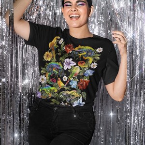 May include: Black t-shirt with a colorful print of tropical flowers, birds, and lizards.