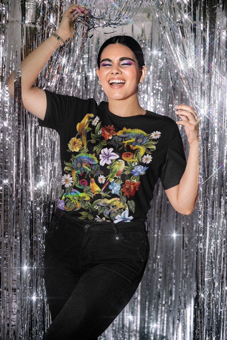 May include: Black t-shirt with a colorful print of tropical flowers, birds, and lizards.