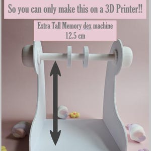 May include: A white 3D-printed Extra Tall Memory dex machine, 12.5 cm tall, with a horizontal rod and circular supports. The text on the image reads: "This is a 3D Printer File. So you can only make this on a 3D Printer!!"