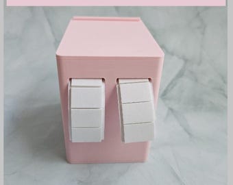 May include: A pale pink 3D-printed item featuring two white rectangular sections. The text at the top says, "This is a 3D Printer File. So you can only make this on a 3D Printer!!"