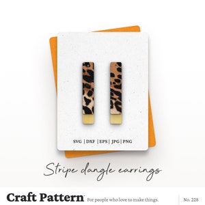 May include: A pair of dangle earrings with a leopard print design and gold accents. The earrings are shown on a white background with a yellow border. SVG | DXF | EPS | JPG | PNG Stripe dangle earrings Craft Pattern For people who love to make things. No. 228