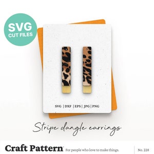 May include: A pair of dangle earrings with a leopard print design and gold accents. The earrings are made of a thin, rectangular shape and are perfect for adding a touch of style to any outfit.