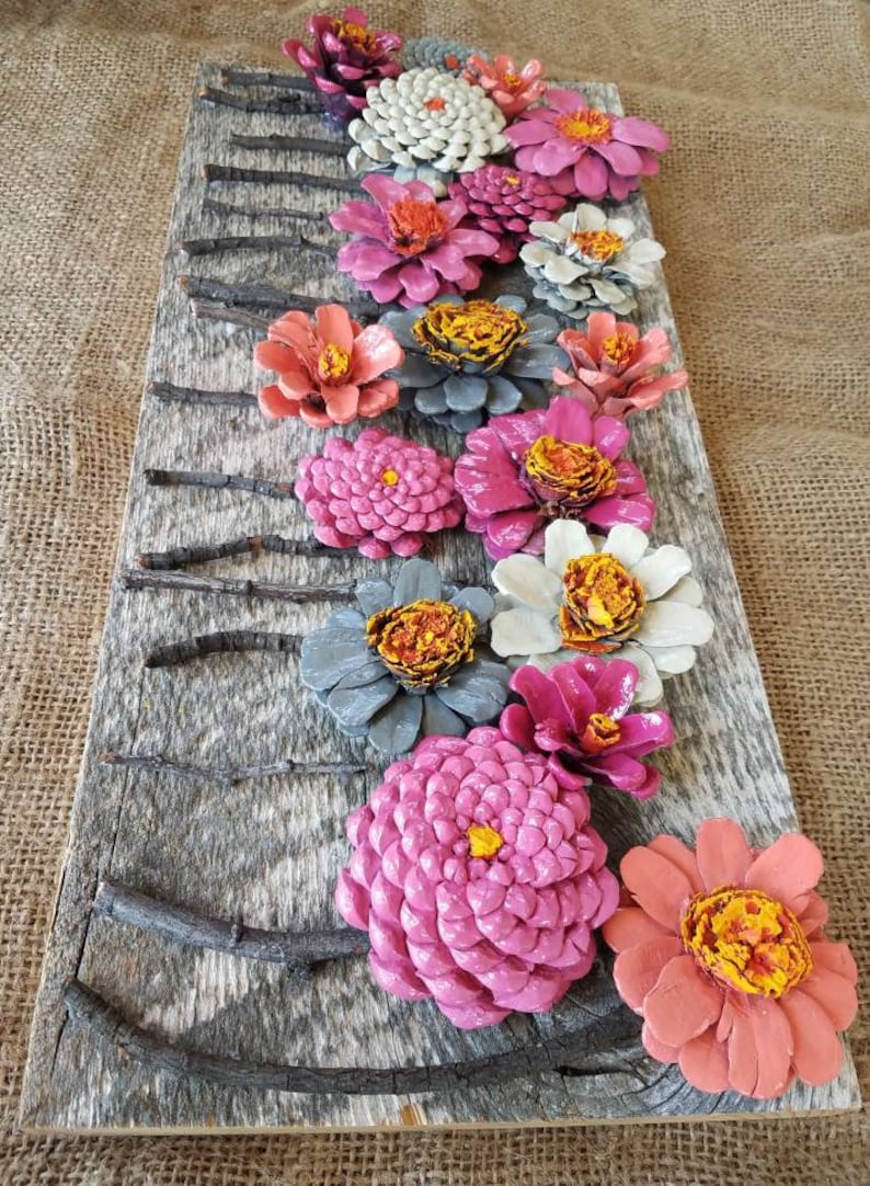 Hand made pinecone flowers on reclaimed barn wood wall | Etsy